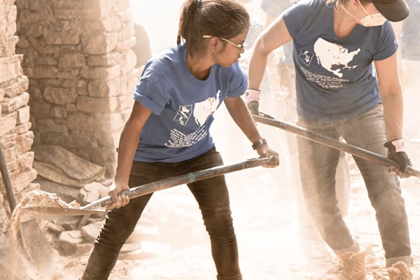 Nepal volunteer shoveling dirt